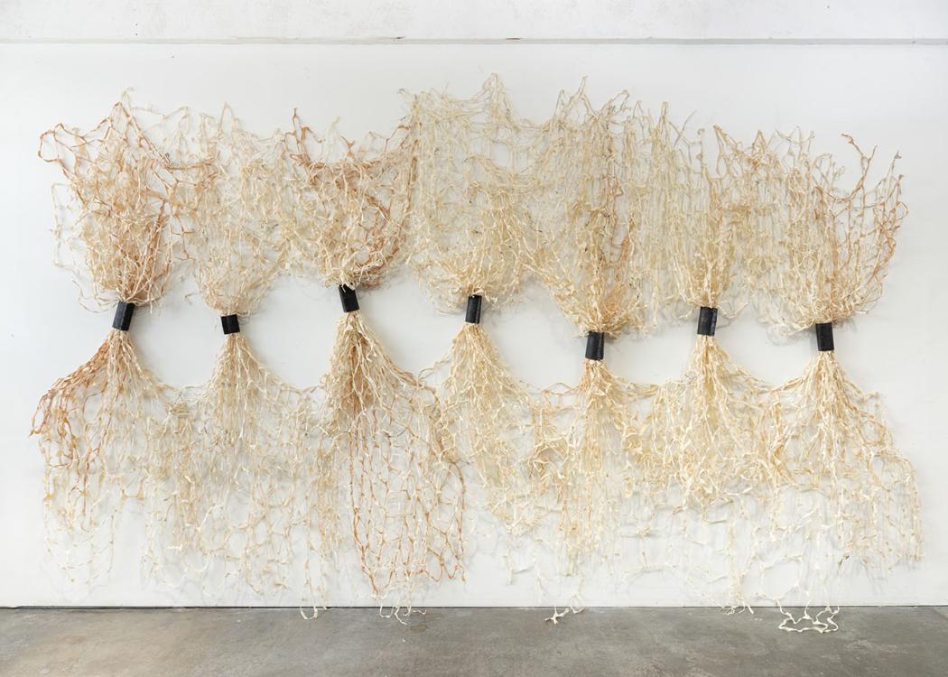 A large, wall-mounted weaving based sculptural artwork