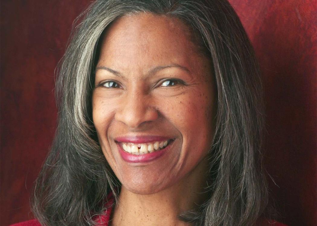 A professional headshot style photograph of a woman