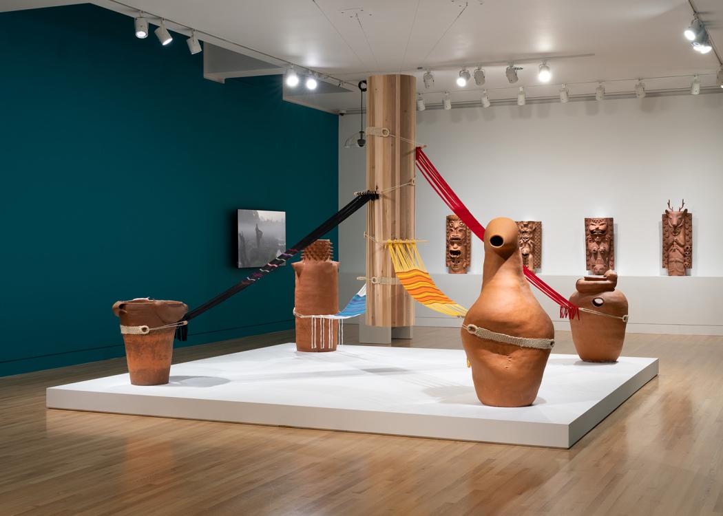 A large room with a central sculptural artwork made of fabric and ceramic