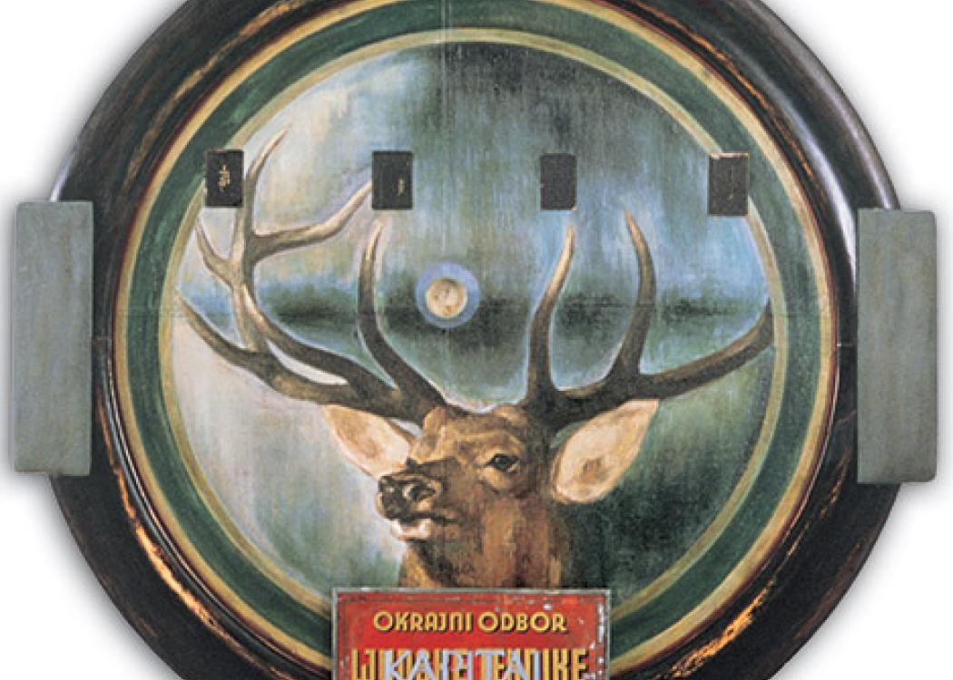 A painting of a deer in a circular frame