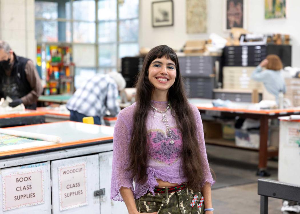 Artist María Zamora standing in a screenprinting studio
