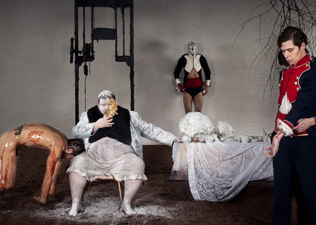 A surreal tableau of people in early 19th century costume dress and various states of undress