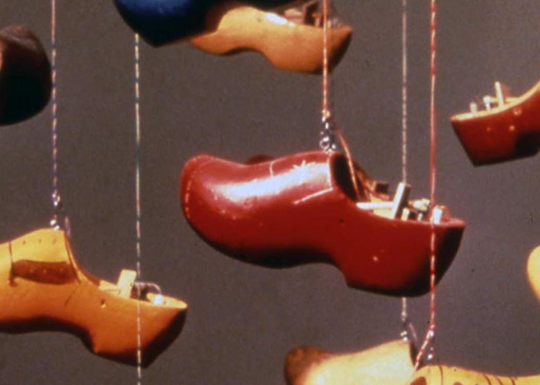Clogs in different colors handing from wires
