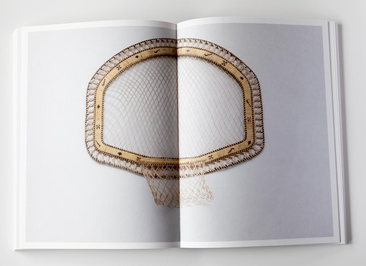 Inside of a book showing an artwork shaped like a basketball hoop and backboard which is intricately woven