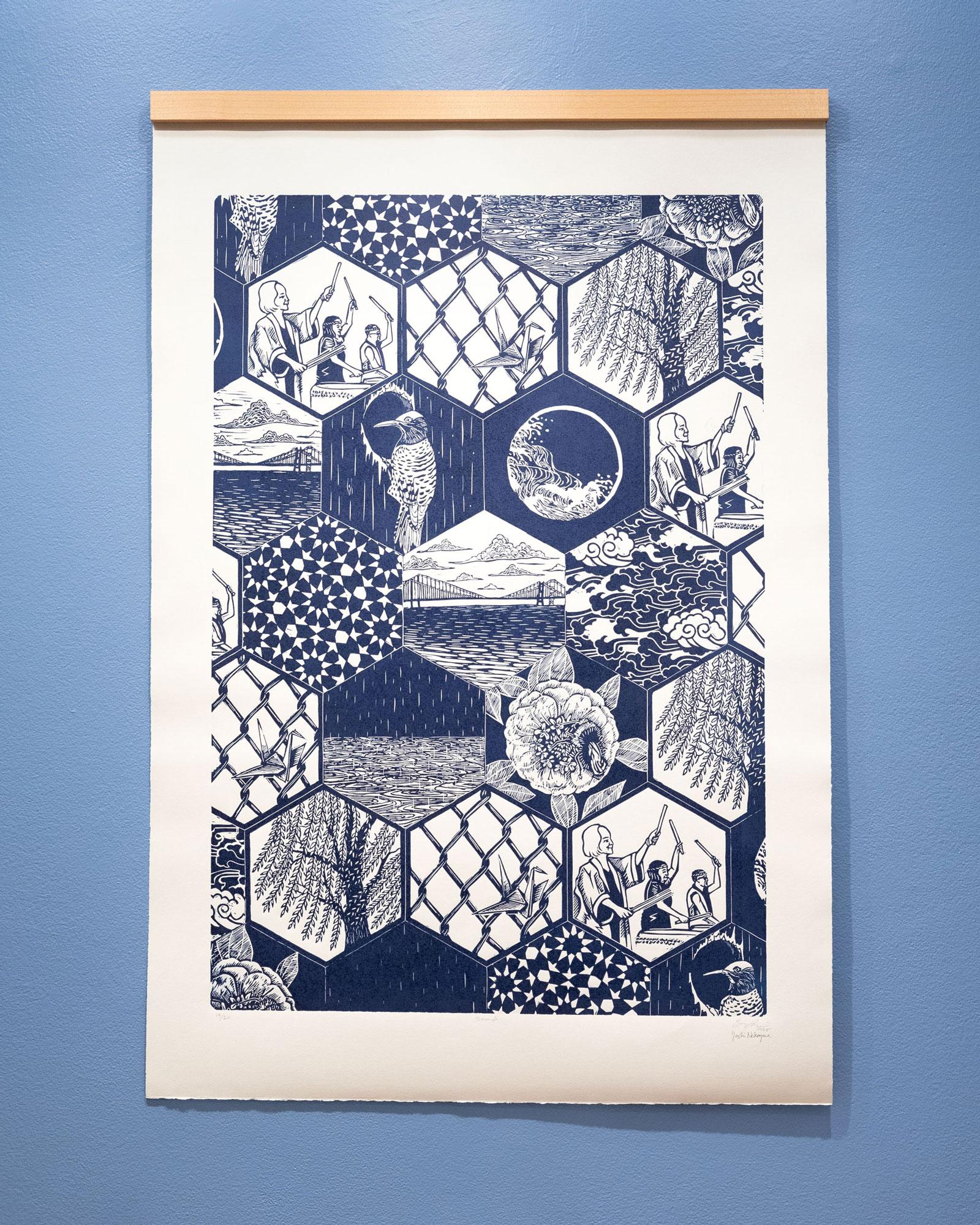 "Sound," a blue and white linocut artwork, hanging on a blue wall