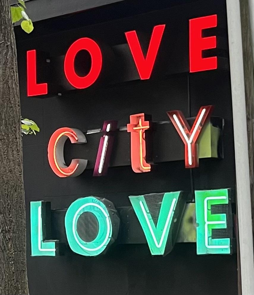 Neon style letters on a building spelling Love City Love